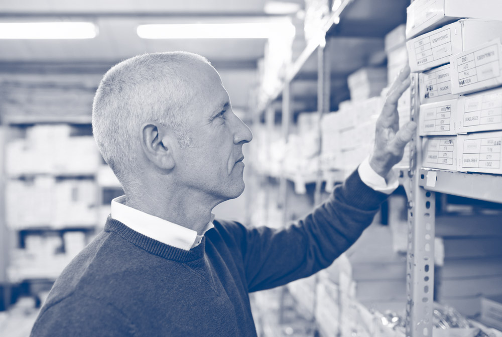 man choosing products off a shelf